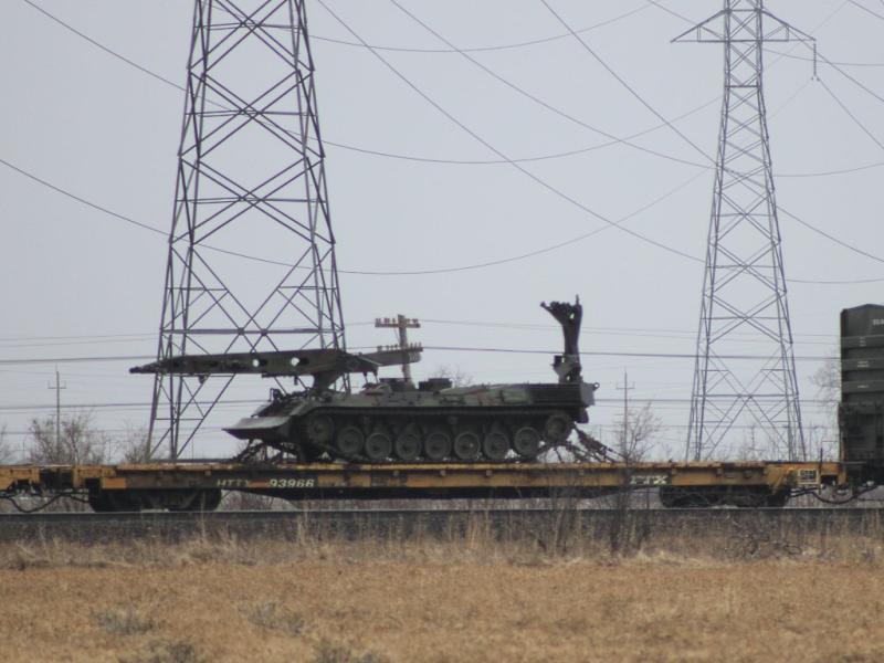 Army engineering vehicle on a train